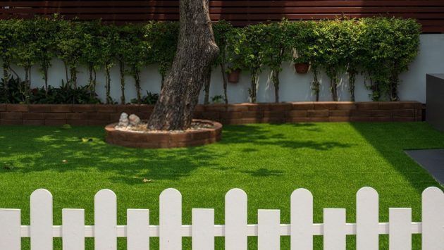 laying artificial grass on soil